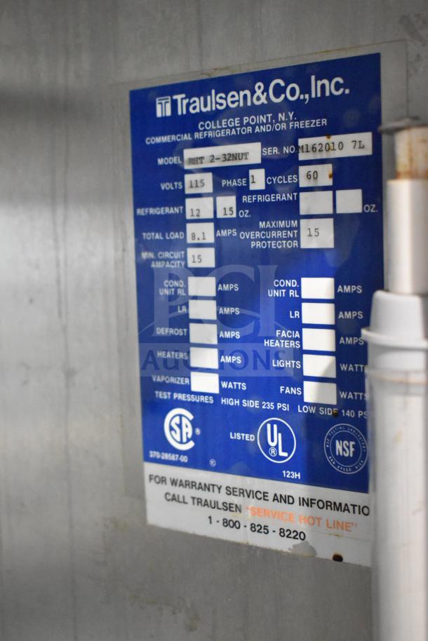 Traulsen RHT 2-32NUT commercial cooler with four half doors, 115V, 1 phase. Label indicates specifications and contact info.