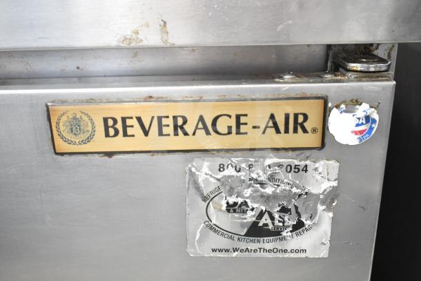 Beverage Air SPE27-B commercial prep table, stainless steel, visible branding, and service stickers, some wear shown.