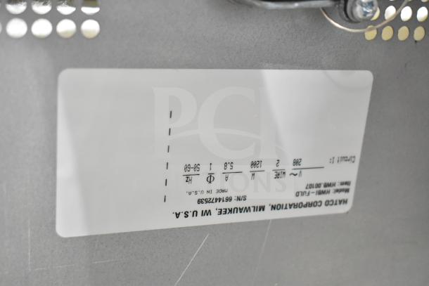 Hatco HWBI-FULD standard watt hot food well label showing model, voltage, and make; minor scratches noted. 