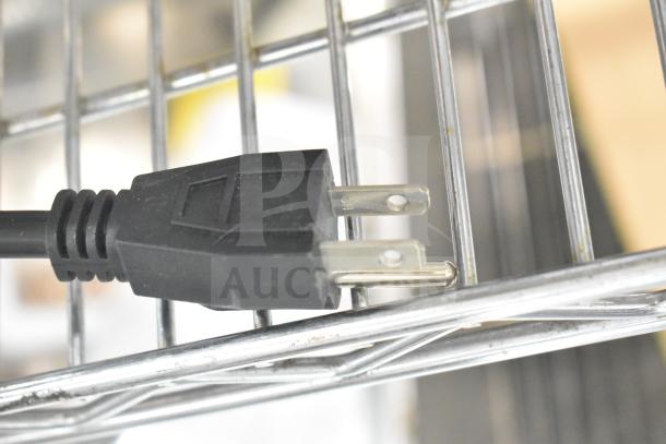 Close-up of a power plug for the Avantco 177RG1818 Hot Dog Roller Grill, showing its compatibility with standard outlets.