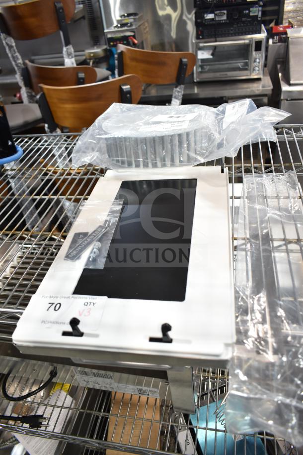 Three brand new scratch and dent items with blower wheel, on a metal shelf. Includes packaged components and labels.