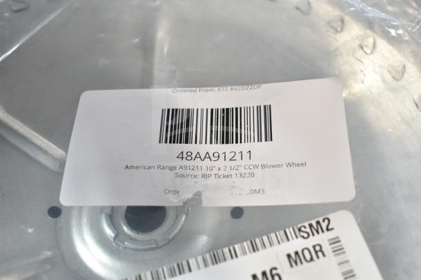 American Range A91211 blower wheel, 10"x2.5", CCW. Tag shows barcode, model, and source info. Brand new condition.