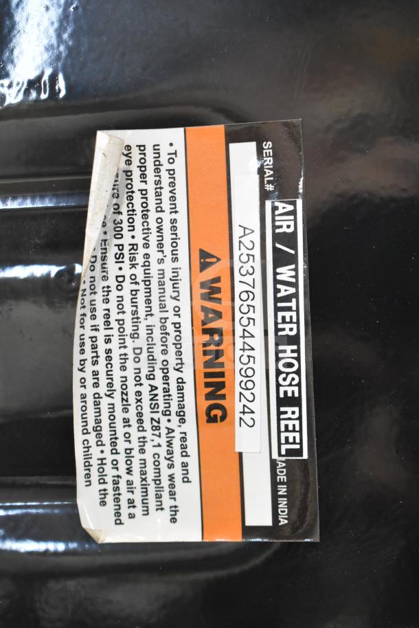 Regency black powder-coated steel hose reel, new, with scratches and dents; includes serial number A253765544599242.