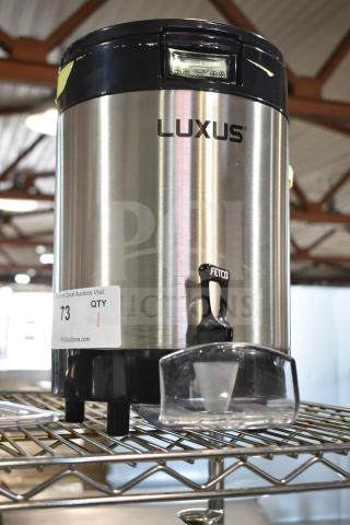 Brand new Fetco L4S-15 Luxus 1.5-gallon stainless steel coffee server, scratch and dent condition, model tag visible.