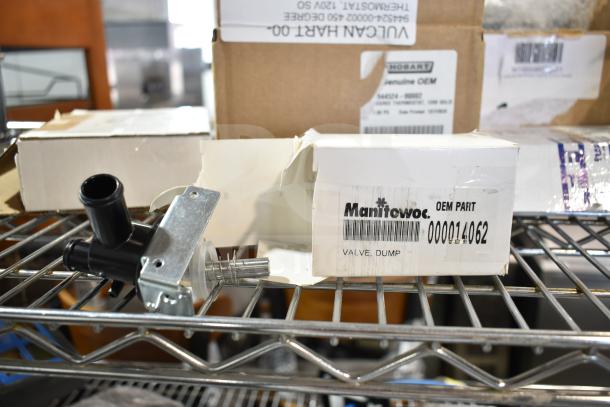6 brand new scratch and dent items, including a Manitowoc OEM dump valve. Visible labels show part numbers.