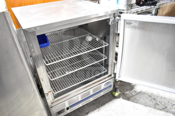 Follett REF5-00-0000 undercounter cooler, single door, stainless steel, 115V, 1 phase, open door showing shelves.