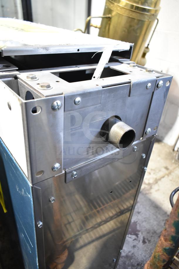 US Range commercial counter, metal construction, visible pipe outlet, stainless steel finish, sturdy design.