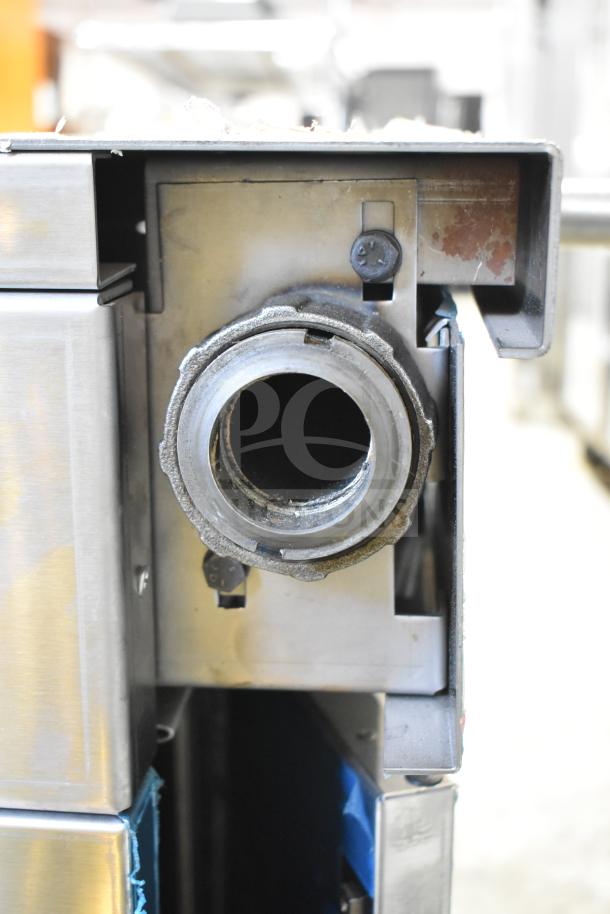 US Range Commercial Counter detail showing sturdy metallic structure, visible wear, and gas connection component.