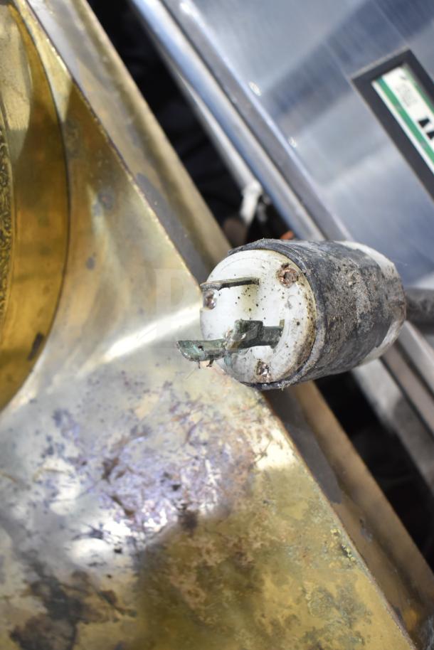 Close-up of an Astra commercial countertop espresso machine's steam wand component, showing signs of wear and patina.