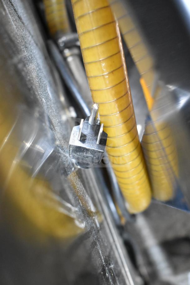 American Dish Service commercial glass washer detail, showing electrical connector and coiled hose in used condition.