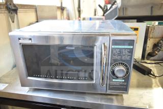 Sharp R-21LCFS countertop microwave oven, stainless steel, commercial model, 1000W, 120V, control dial visible.
