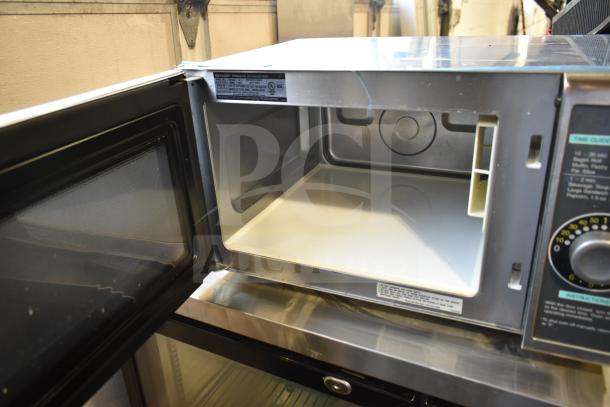 Sharp R-21LCFS countertop microwave oven, open view. Good condition, visible labels detail 120V, 1 Phase.