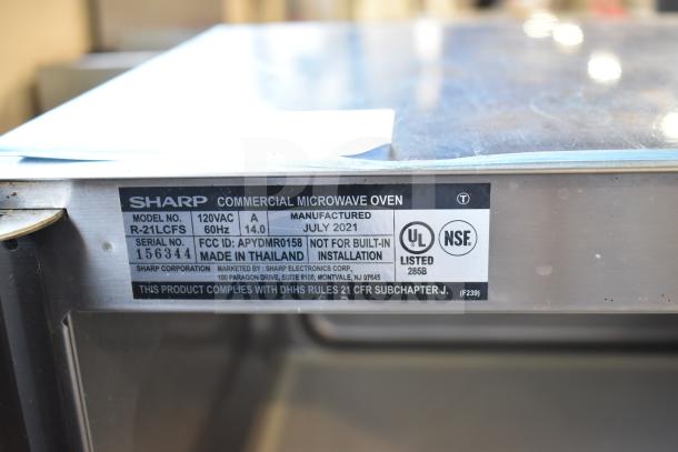 Sharp R-21LCFS Countertop Microwave Oven, 120V, 1 Phase. Label shows model and serial number, made in Thailand, 2021.