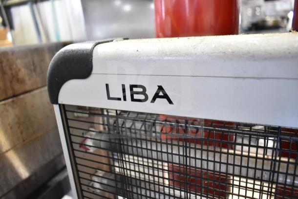 Liba bug zapper with visible branding, alongside red fire extinguishers. Items are pre-owned, pickup required.