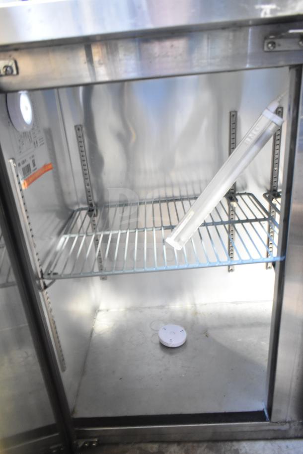 Spartan SGBB-79 Commercial 3 Door Back Bar Cooler, 115V, shown open with wire shelving and interior lighting.