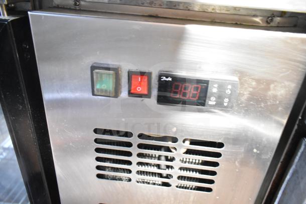 Spartan SGBB-79 3 Door Back Bar Cooler control panel with power switches and digital temperature display.