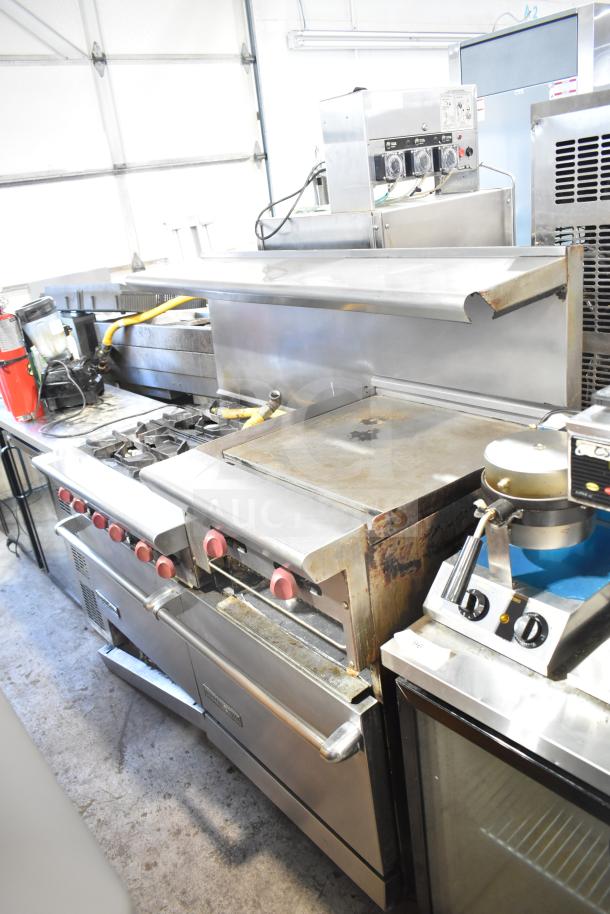 American Range commercial 6 burner range with flat top, 2 ovens, over shelf, and backsplash. Good condition.