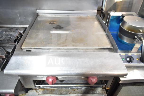American Range commercial 6 burner range with flat top, two ovens, over shelf, and backsplash. Used condition.