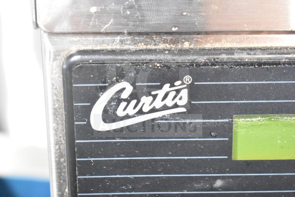 Curtis ALP3GT12A000 commercial coffee machine, stainless steel, branded panel, used condition, 120V, 1 Phase.