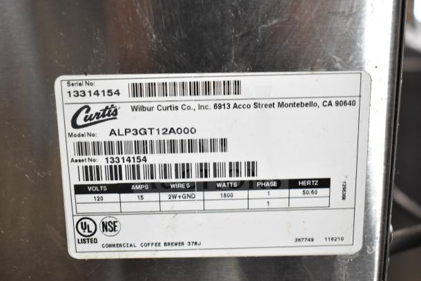Curtis ALP3GT12A000 coffee machine label showing model, voltage, watts, and serial number. Marks show UL and NSF listings.