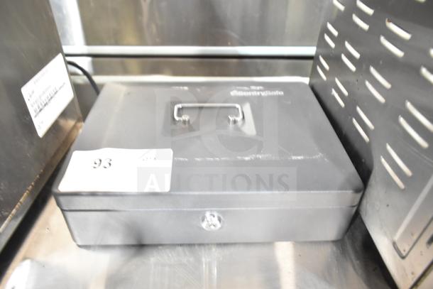SentrySafe metal cash box, black, with handle, key lock, and label "93." Appears in good condition.