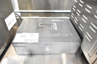 SentrySafe metal cash box, black, with handle, key lock, and label "93." Appears in good condition.