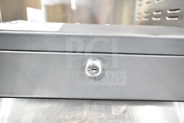 SentrySafe metal cash box with key lock. Black finish, compact design, excellent condition. Keyhole marked SAT.