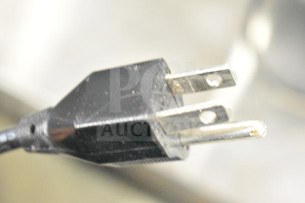 Close-up of a power plug, part of an auction including Furman M-8Lx, dbx Zone Pro 640m, Insignia NS-STR514, Crown CDi2000.