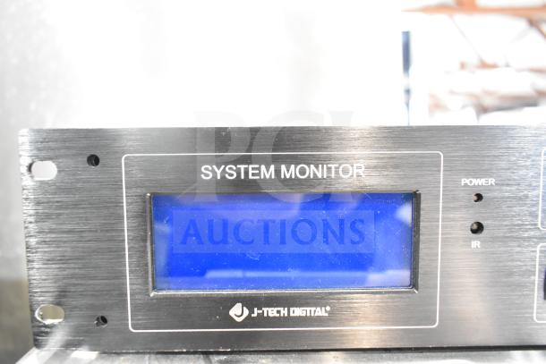 J-Tech Digital system monitor with blue display, labeled "SYSTEM MONITOR." Black metal casing, front panel view.