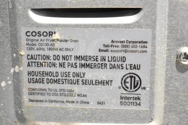 Cosori CO130-AO Air Fryer Toaster Oven label showing voltage, safety warnings, and certification details.