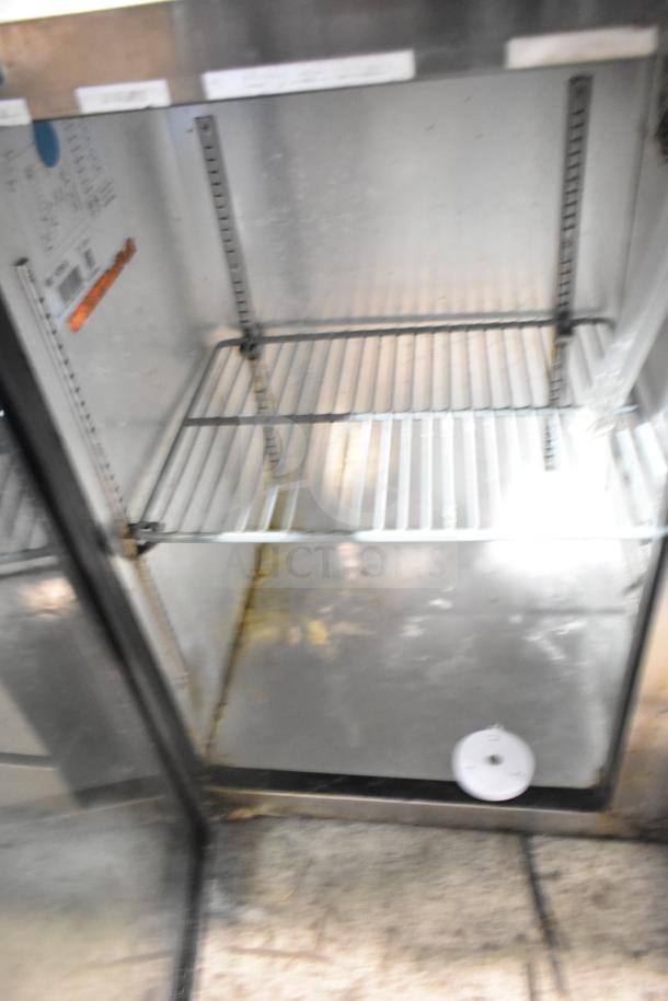 Spartan SGBB-58 commercial back bar cooler, 2 doors, 115V, 1 phase. Visible shelves and interior wear. Model label inside.