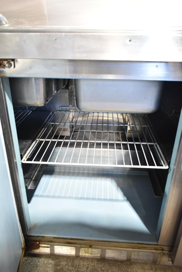 Delfield 4472N-18M commercial prep table; stainless steel, interior view, metal shelving, single phase, 115 volts.