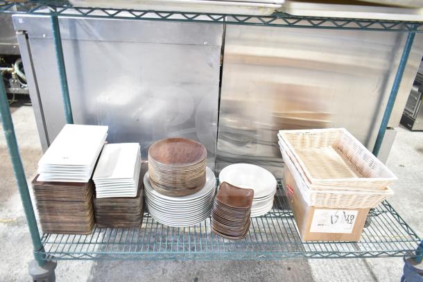 Tiered shelf with various kitchen items, including stacks of rectangular plates, round plates, and wicker baskets.