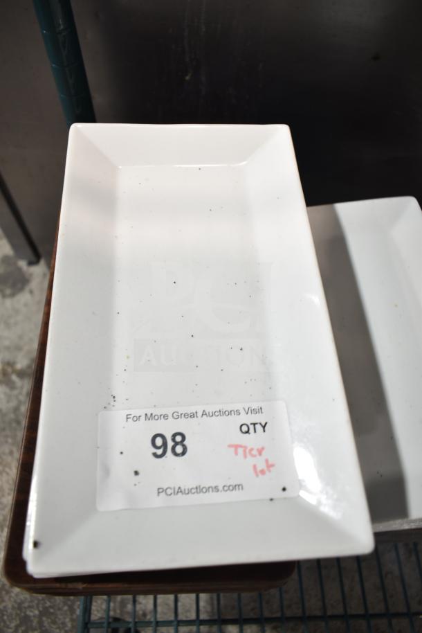 Rectangular white plate with a label reading "98 QTY Tier Lot, PCIAuctions.com." Part of a varied item auction lot.