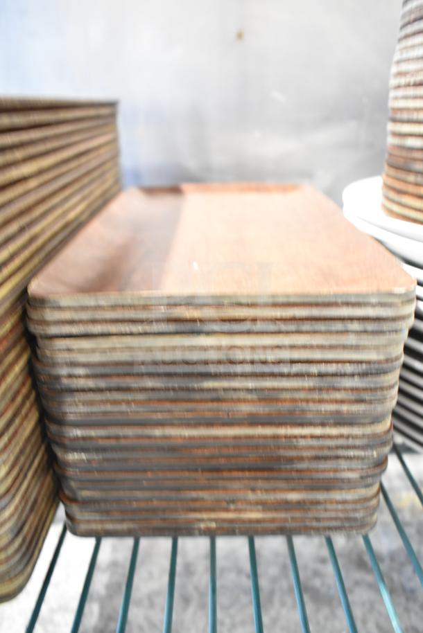 Stack of rectangular plates on a shelf, showing a tier lot of various items including baskets. Good condition, auction lot.