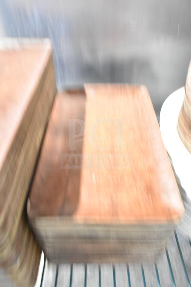 Blurry image of a tiered lot with wooden rectangular plates. Condition and specific details indistinct.