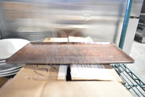 Tiered lot includes a rectangular wooden plate on cardboard boxes, showcasing a rustic finish.