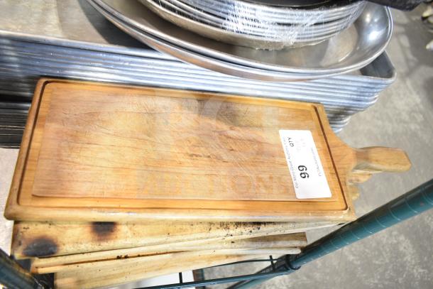 Auction lot with baking pans, stainless steel bins, china cap strainer, stock pot, cutting boards, and knives. Used condition.