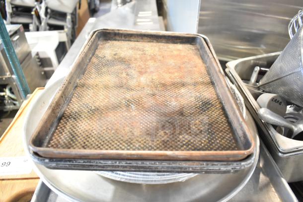 Tier lot with baking pans, stainless steel drop-in bins, china cap strainer, stock pot, cutting boards, and knives. Mixed condition.