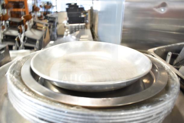 Alt text: Tier lot of mixed kitchen items, featuring baking pans and stainless-steel bins in good condition in an auction setting.