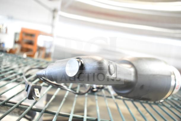 Galaxy 177IMBL9 Immersion Blender, black handle, plug visible, 110-120V, good condition, resting on metal rack.