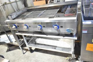 Globe gas-powered charbroiler grill on stand with casters, stainless steel, four controls, clean condition, model branding visible.