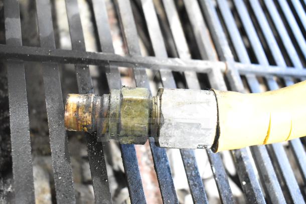 Gas connection of a Globe Commercial Countertop Gas Charbroiler Grill. Features durable cast iron grates.