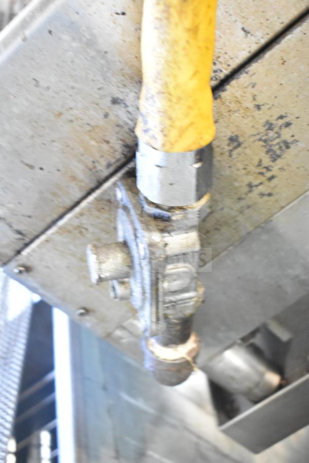 Gas valve handle on Globe Commercial Countertop Gas Powered Charbroiler Grill. Appears used with visible wear.