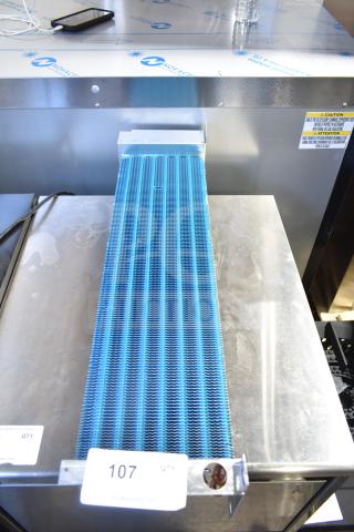 Brand new evaporator coil with blue fins. Slight scratches on metal. Includes safety and model labels. Auction tag "107".