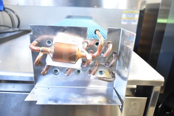 Brand new scratch and dent evaporator coil, showing visible copper tubing and metal casing, minor cosmetic imperfections.