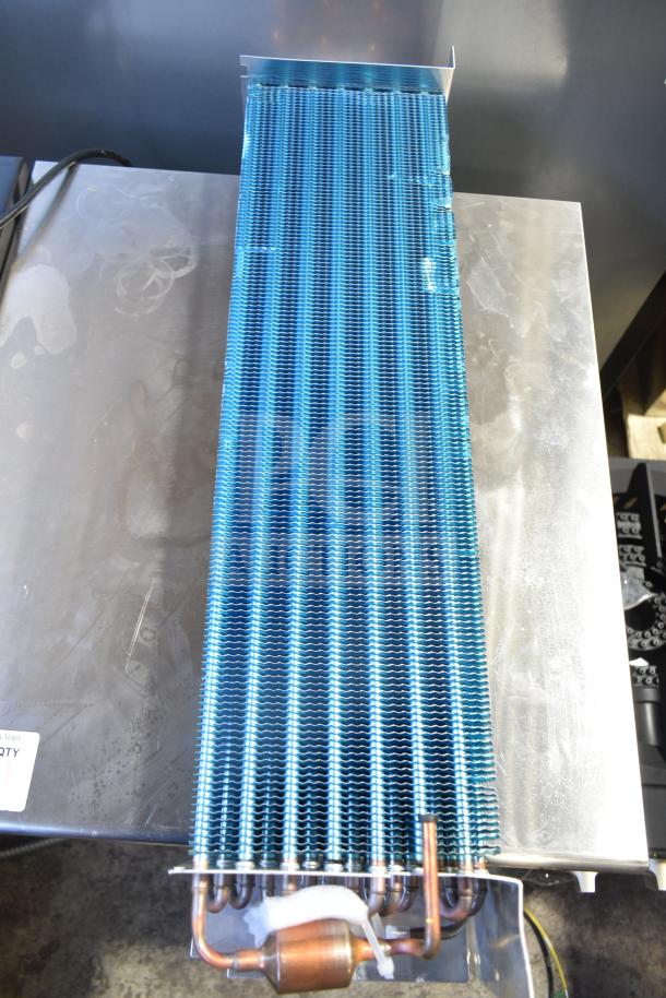 Brand new scratch and dent evaporator coil, blue fins, copper piping, slight surface imperfections visible.