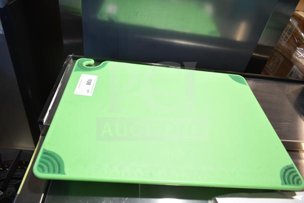 Brand new green cutting board with corner grips. Labeled "108" for scratch and dent condition.