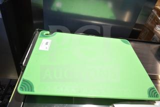 Brand new green cutting board with corner grips. Labeled "108" for scratch and dent condition.