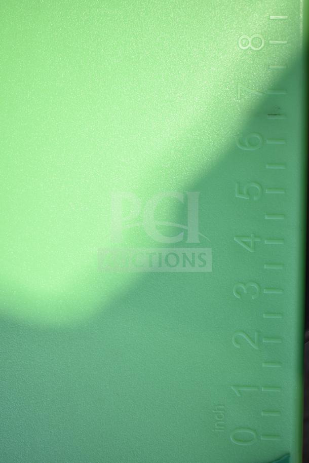 Brand new green cutting board with inch markings, slight scratch visible. Durable surface, ideal for kitchen use.